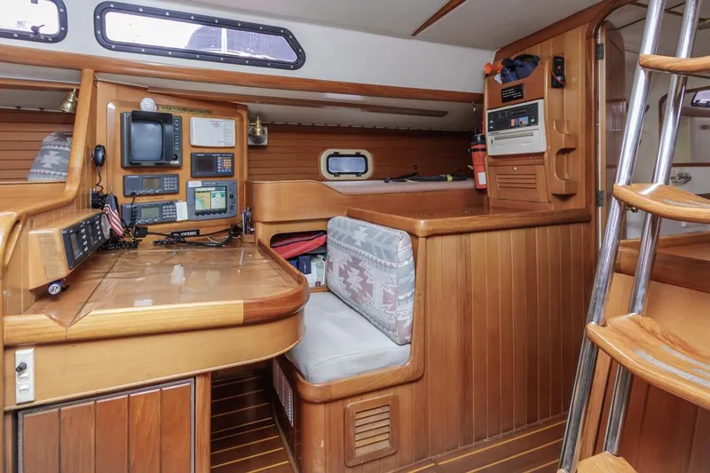 Jano Yacht Photos Pics Interior of 1994 Farr 55 yacht with navigation station and wooden furnishings.