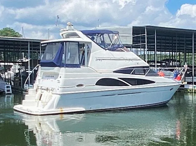 Diversion Yacht Photos Pics 2006 Carver 36 Motor Yacht docked in a marina under a partly cloudy sky.
