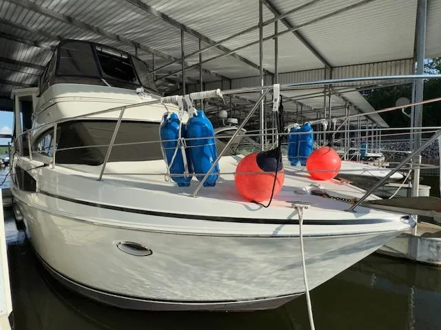 Diversion Yacht Photos Pics 2006 Carver 36 Motor Yacht docked under a covered marina with fenders and buoys.