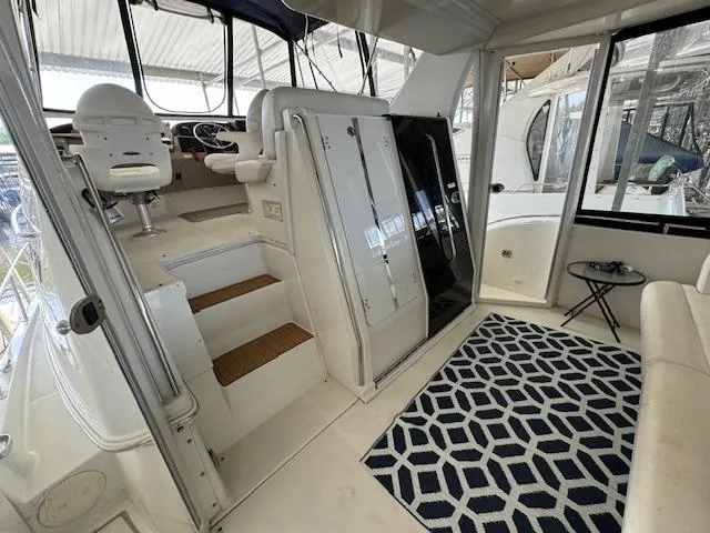 Diversion Yacht Photos Pics 2006 Carver 36 Motor Yacht interior with seating, stairs, and geometric rug.