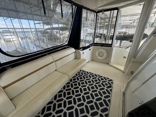 Diversion Yacht Photos Pics 2006 Carver 36 Motor Yacht interior with white seating and geometric rug.