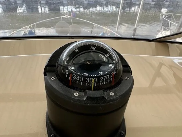 Diversion Yacht Photos Pics Compass on 2006 Carver 36 Motor Yacht dashboard, overlooking marina waters.