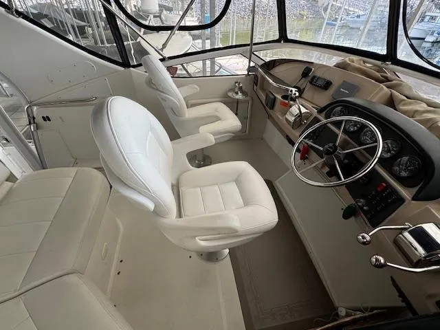 Diversion Yacht Photos Pics 2006 Carver 36 Motor Yacht helm with white seating and navigation controls.