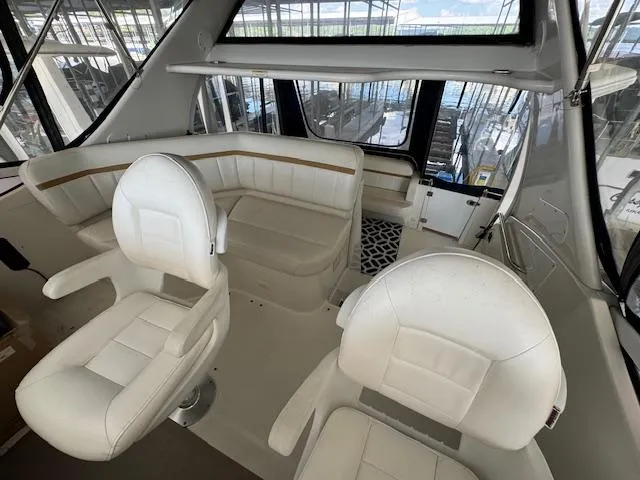 Diversion Yacht Photos Pics 2006 Carver 36 Motor Yacht interior with white seating and panoramic windows.