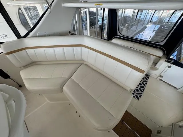 Diversion Yacht Photos Pics 2006 Carver 36 Motor Yacht interior with white leather seating and panoramic windows.