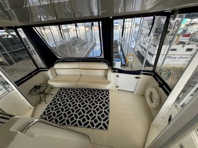 Diversion Yacht Photos Pics 2006 Carver 36 Motor Yacht interior with seating, geometric rug, and marina view.