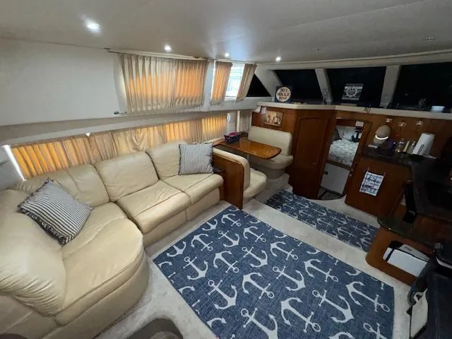 Diversion Yacht Photos Pics Interior of 2006 Carver 36 Motor Yacht with beige sofa and nautical-themed decor.