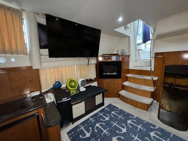 Diversion Yacht Photos Pics Interior of 2006 Carver 36 Motor Yacht with TV, stairs, and nautical-themed decor.