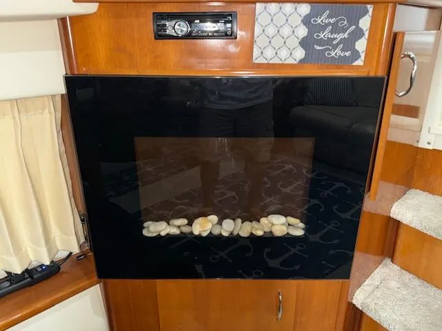 Diversion Yacht Photos Pics 2006 Carver 36 Motor Yacht interior with modern fireplace and decorative sign.