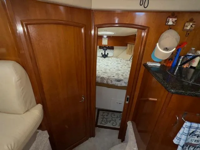 Diversion Yacht Photos Pics Interior of 2006 Carver 36 Motor Yacht with wood paneling and cozy bedroom.