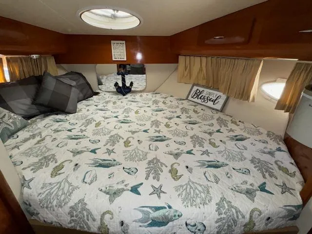 Diversion Yacht Photos Pics Cozy bedroom in 2006 Carver 36 Motor Yacht with nautical-themed bedding and decorative pillows.