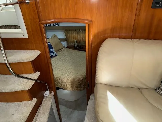 Diversion Yacht Photos Pics 2006 Carver 36 Motor Yacht interior with stairs, cozy bedroom, and beige seating.