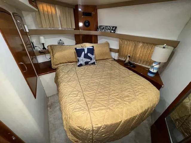 Diversion Yacht Photos Pics 2006 Carver 36 Motor Yacht bedroom with cozy bed and nautical decor.