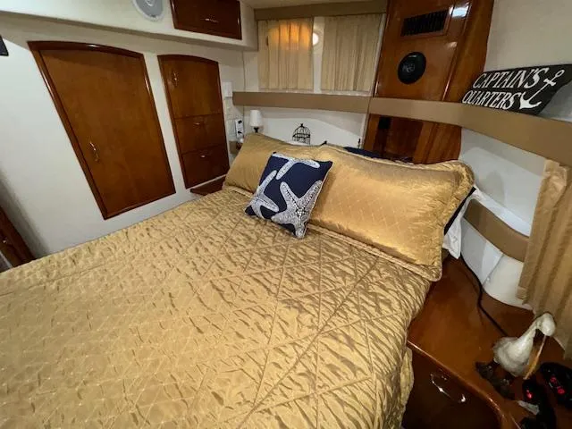 Diversion Yacht Photos Pics Luxurious bedroom in 2006 Carver 36 Motor Yacht with gold bedding and nautical decor.