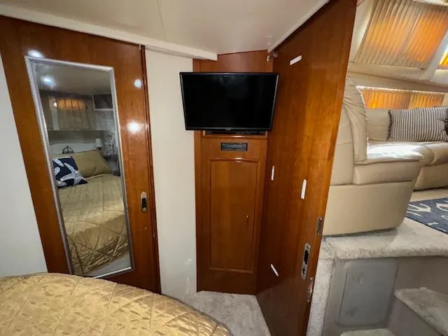 Diversion Yacht Photos Pics Interior of 2006 Carver 36 Motor Yacht with TV, mirror, and cozy seating area.
