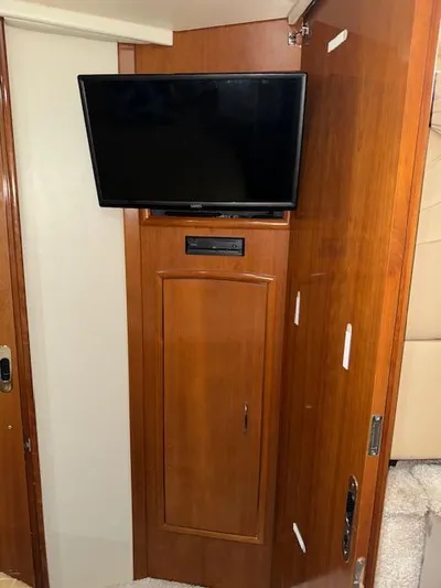 Diversion Yacht Photos Pics 2006 Carver 36 Motor Yacht interior with mounted TV and wooden cabinetry.