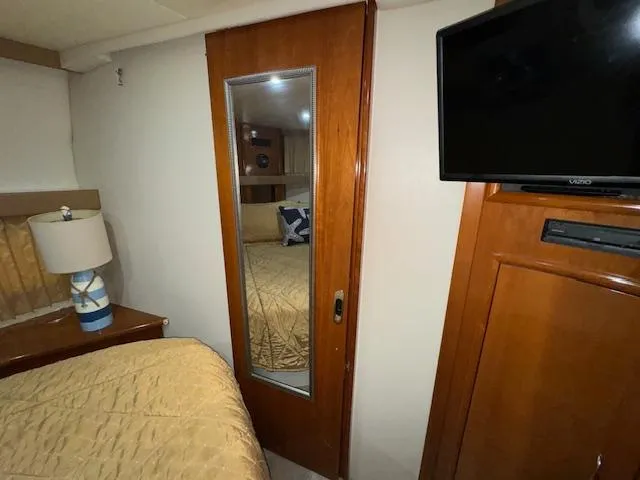 Diversion Yacht Photos Pics Interior of 2006 Carver 36 Motor Yacht with mirror, TV, and bed.