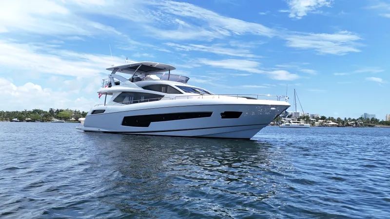 Dirty Dawg Yacht Photos Pics 2017 Sunseeker 75 Yacht on calm water under a clear blue sky.