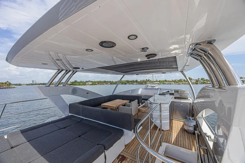 Dirty Dawg Yacht Photos Pics Luxurious 2017 Sunseeker 75 Yacht with spacious deck and modern amenities, overlooking serene waters.