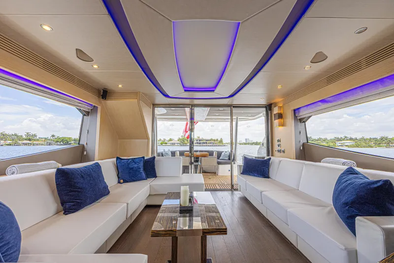 Dirty Dawg Yacht Photos Pics Luxurious interior of 2017 Sunseeker 75 Yacht with white seating and blue accents.