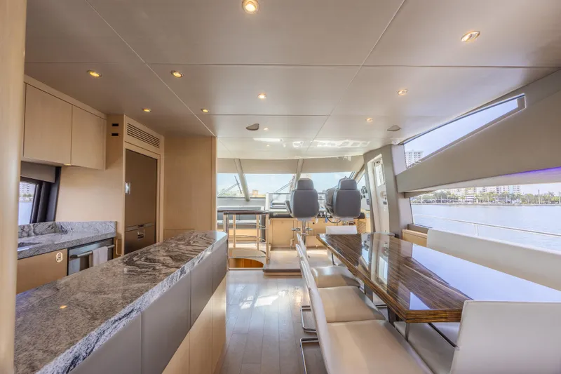 Dirty Dawg Yacht Photos Pics Luxurious interior of 2017 Sunseeker 75 Yacht with modern dining area and panoramic windows.