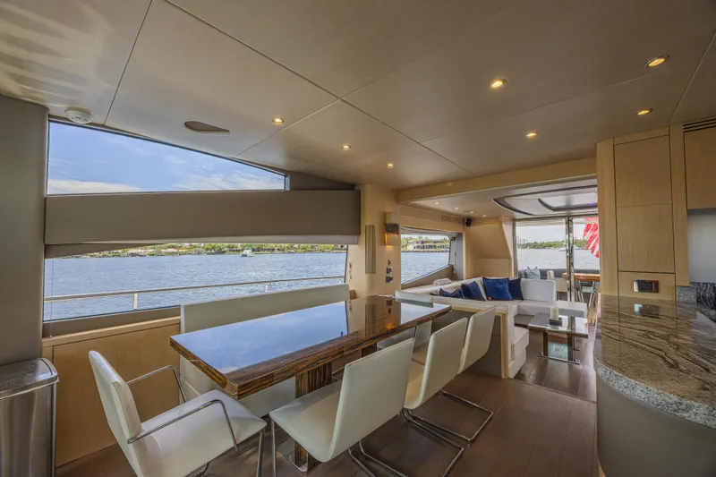 Dirty Dawg Yacht Photos Pics Luxurious interior of 2017 Sunseeker 75 Yacht with elegant dining and seating area.