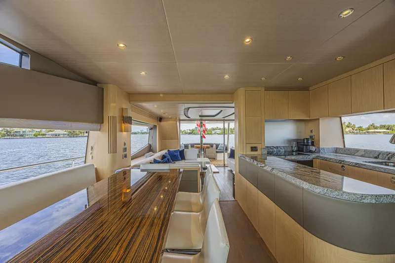 Dirty Dawg Yacht Photos Pics Luxurious interior of 2017 Sunseeker 75 Yacht with modern kitchen and dining area.