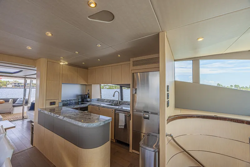 Dirty Dawg Yacht Photos Pics Luxurious interior of 2017 Sunseeker 75 Yacht featuring modern kitchen and scenic views.