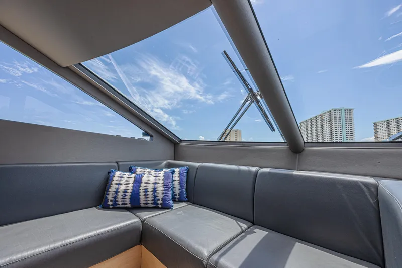 Dirty Dawg Yacht Photos Pics Luxurious interior of 2017 Sunseeker 75 Yacht with panoramic windows and plush seating.