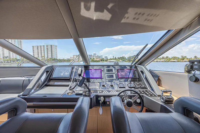 Dirty Dawg Yacht Photos Pics Luxurious 2017 Sunseeker 75 Yacht helm with modern navigation systems and waterfront view.