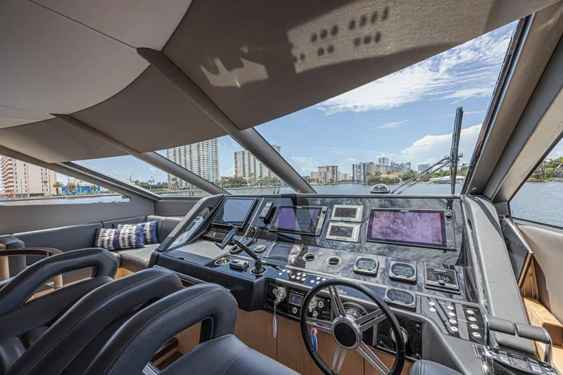 Dirty Dawg Yacht Photos Pics Luxurious 2017 Sunseeker 75 Yacht helm with modern navigation equipment and panoramic city views.
