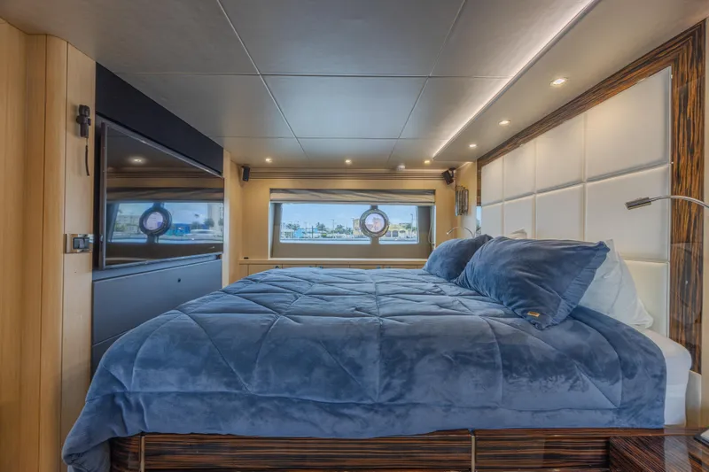 Dirty Dawg Yacht Photos Pics Luxurious bedroom interior of 2017 Sunseeker 75 Yacht with plush bedding and modern design.