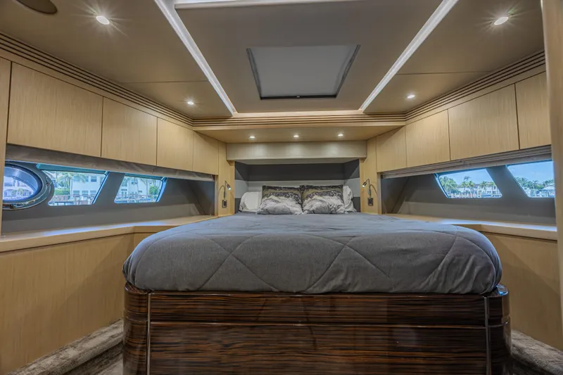 Dirty Dawg Yacht Photos Pics Luxurious bedroom interior of 2017 Sunseeker 75 Yacht with modern design and ambient lighting.