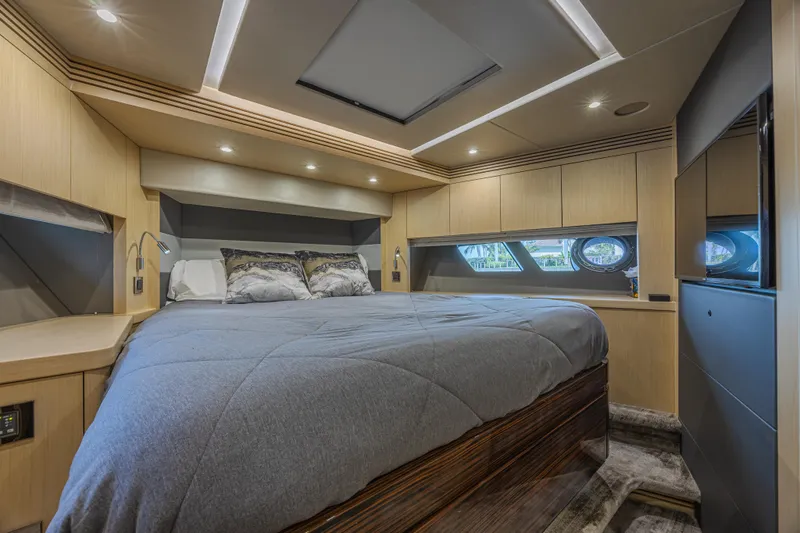 Dirty Dawg Yacht Photos Pics Luxurious bedroom interior of 2017 Sunseeker 75 Yacht with modern design and ambient lighting.