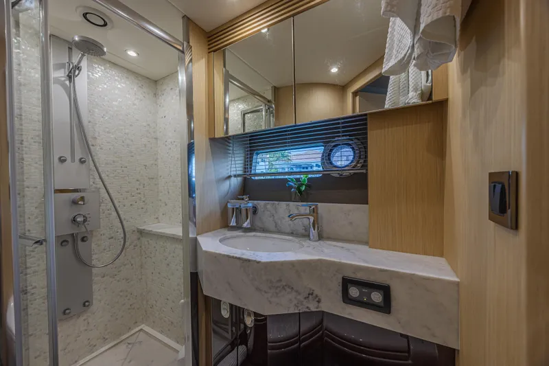 Dirty Dawg Yacht Photos Pics Luxurious bathroom in 2017 Sunseeker 75 Yacht with marble sink and modern shower.