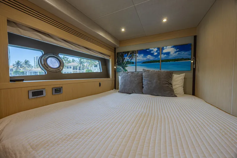 Dirty Dawg Yacht Photos Pics Luxurious bedroom interior of 2017 Sunseeker 75 Yacht with scenic window view.