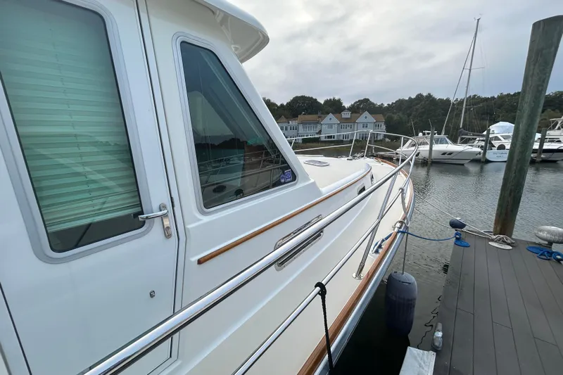  Yacht Photos Pics 2015 Sabre 42 Salon Express yacht docked at marina with scenic background.