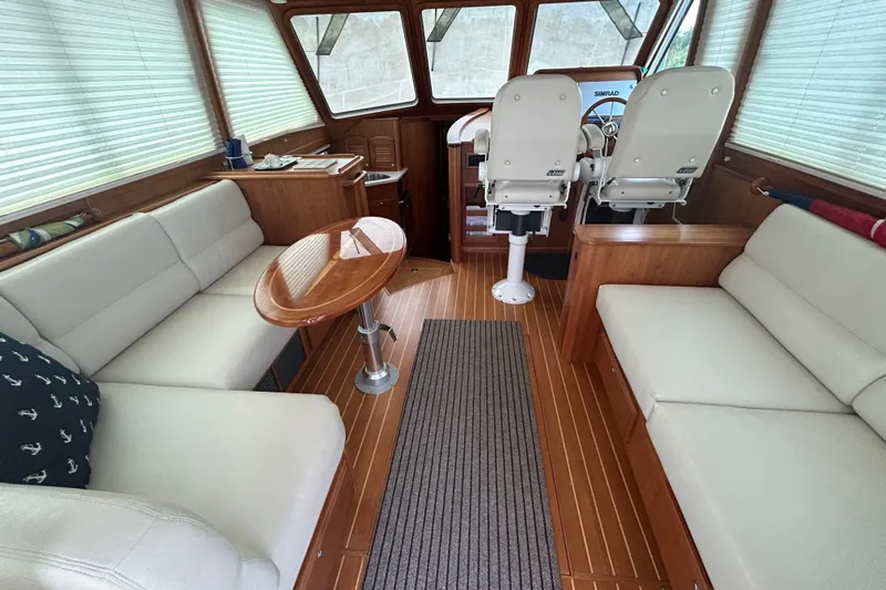  Yacht Photos Pics Interior of 2015 Sabre 42 Salon Express with elegant seating and wooden finishes.