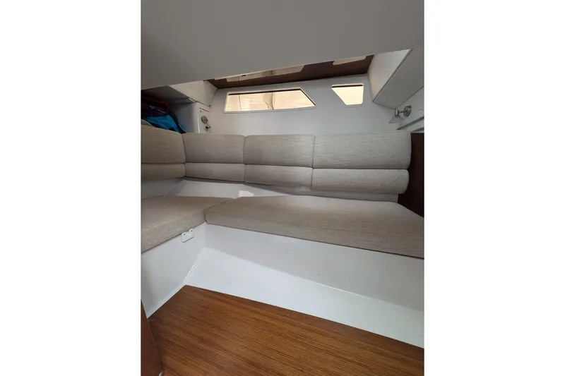  Yacht Photos Pics Interior cabin of 2018 Four Winns H350 boat with beige seating and wooden flooring.