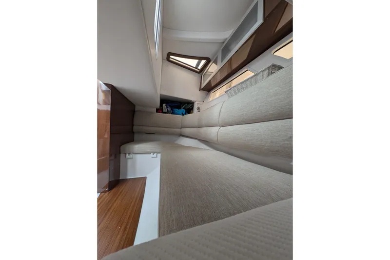  Yacht Photos Pics Interior cabin of 2018 Four Winns H350 boat with beige seating and wooden flooring.