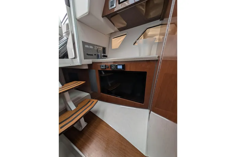  Yacht Photos Pics 2018 Four Winns H350 cabin interior with wooden steps and modern control panel.