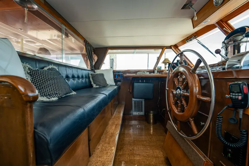 Coconut Yacht Photos Pics Interior of a 1964 Burger 64' Motor Yacht with wooden helm and leather seating.