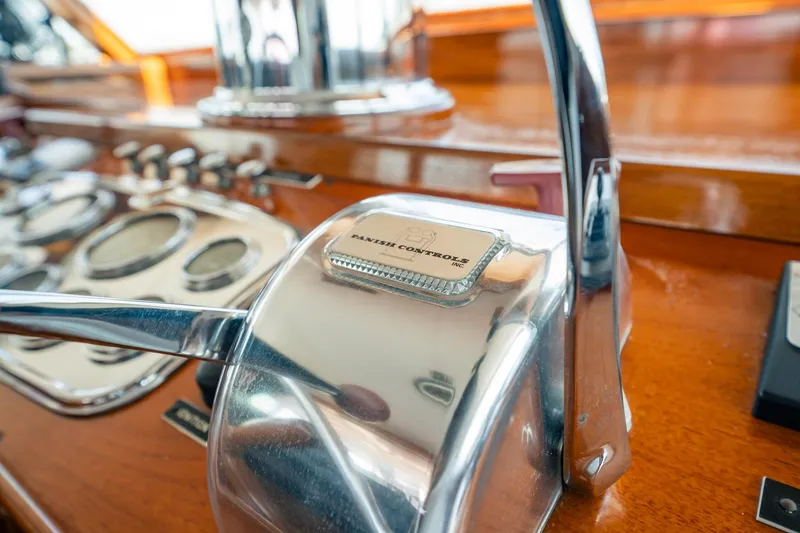 Coconut Yacht Photos Pics Close-up of 1964 Burger 64' Motor Yacht control panel with polished levers and dials.