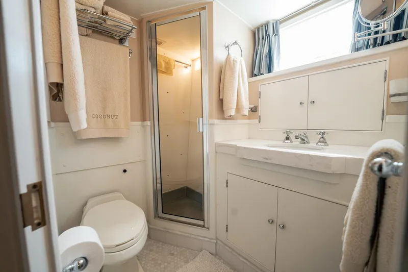 Coconut Yacht Photos Pics Bathroom interior of 1964 Burger 64' Motor Yacht with shower and vanity.