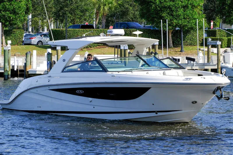 Sensei I Yacht Photos Pics 2021 Sea Ray SLX 400 luxury boat cruising on a sunny day near a marina.