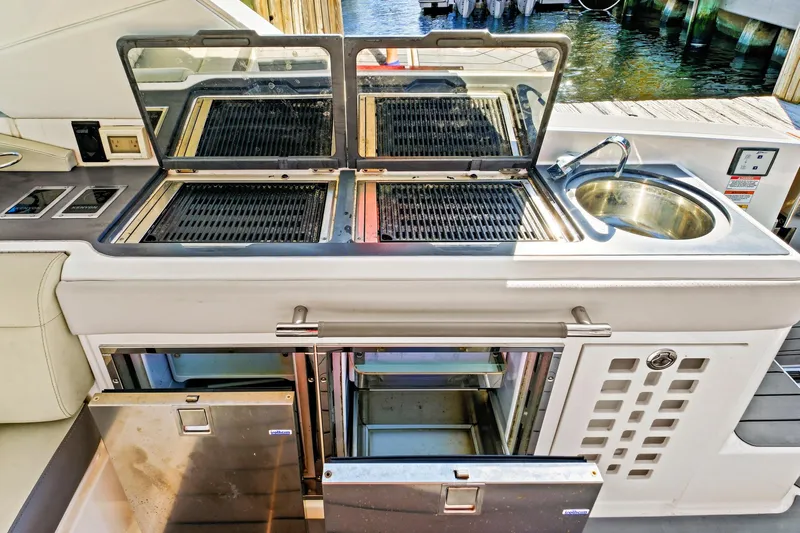 Sensei I Yacht Photos Pics Outdoor kitchen on 2021 Sea Ray SLX 400 yacht with grill, sink, and storage.
