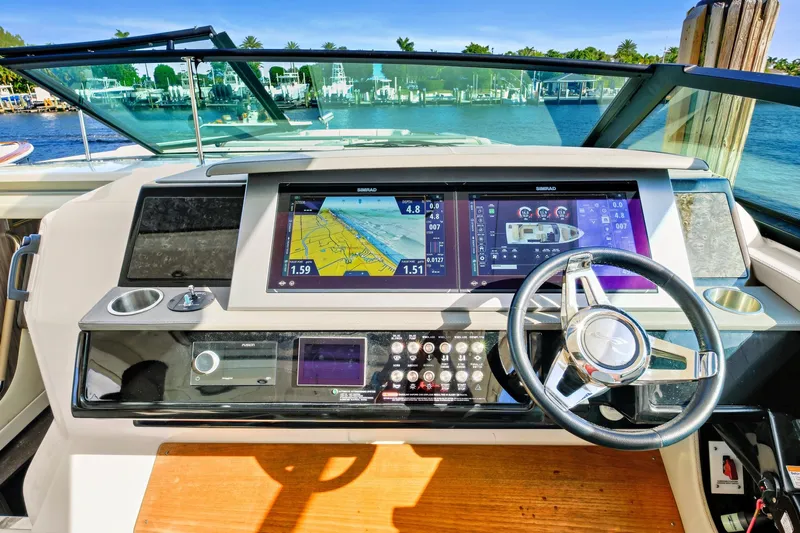 Sensei I Yacht Photos Pics Dashboard of 2021 Sea Ray SLX 400 boat with navigation screens and steering wheel.