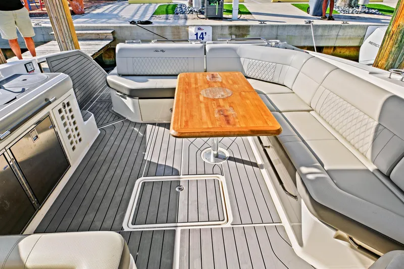 Sensei I Yacht Photos Pics Luxurious seating area on 2021 Sea Ray SLX 400 boat with wooden table and modern design.