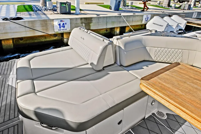 Sensei I Yacht Photos Pics Luxurious seating area on 2021 Sea Ray SLX 400 boat, featuring elegant upholstery and wooden table.