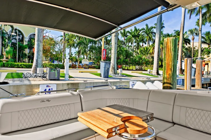 Sensei I Yacht Photos Pics Interior view of 2021 Sea Ray SLX 400 yacht with luxurious seating and tropical marina backdrop.